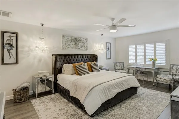 a bedroom with furniture and a flat screen tv