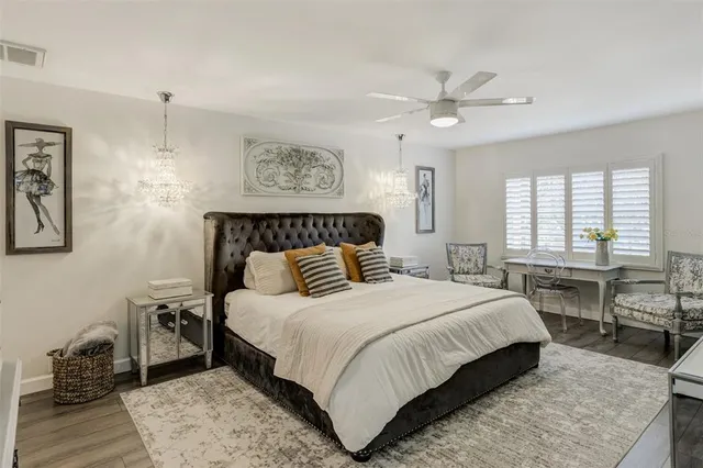 a bedroom with furniture and a flat screen tv