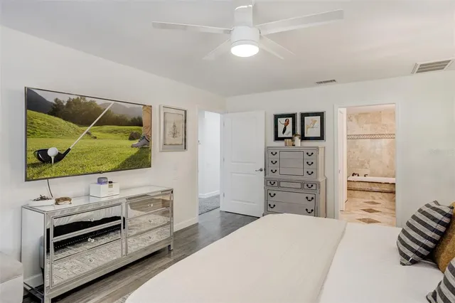 a spacious bathroom with a sink double vanity granite tub shower and a mirror