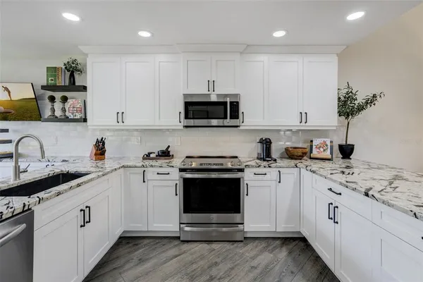 a kitchen with a sink stove and cabinets