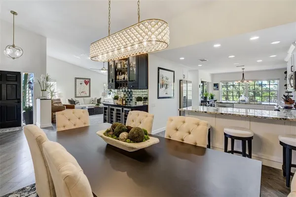 a living room with furniture and chandelier