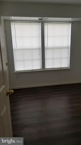 a bathroom with a sink a toilet a light fixture and a mirror