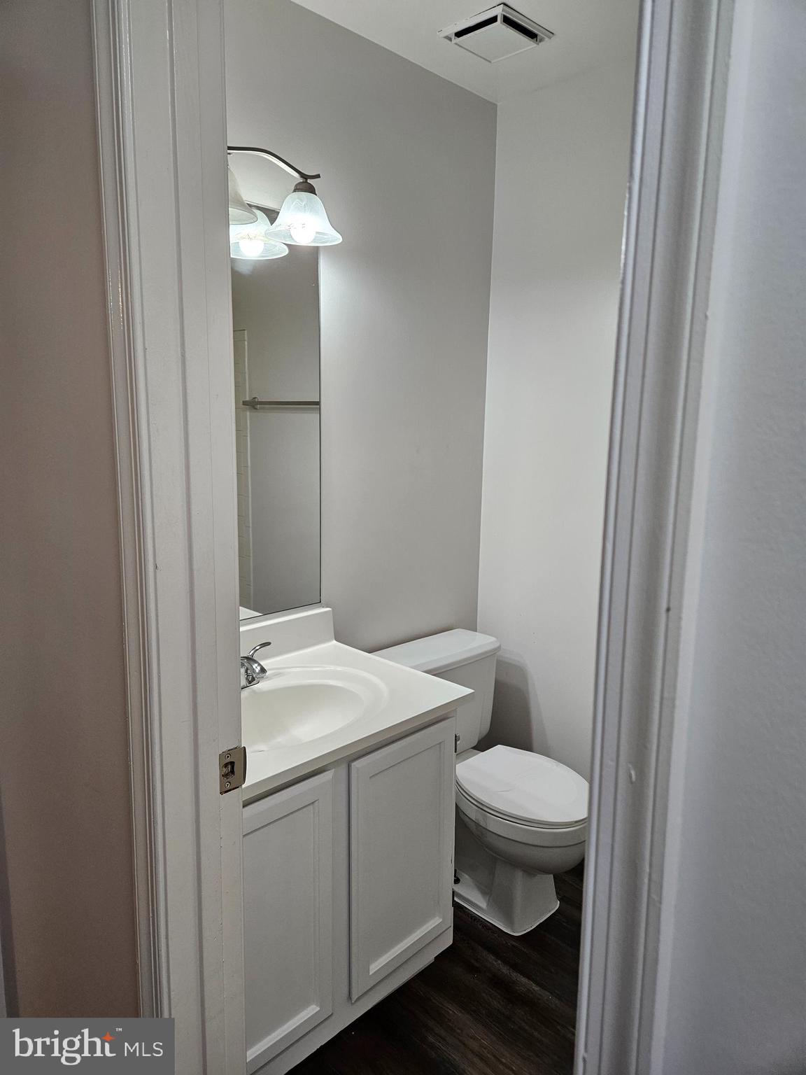 2040 Alice Avenue, Unit 2040201 Oxon Hill, MD 20745 - Photo 13 of 15 a bathroom with a sink a toilet a light fixture and a mirror