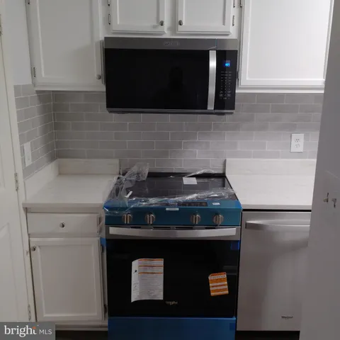 a close view of a stove a microwave and cabinets
