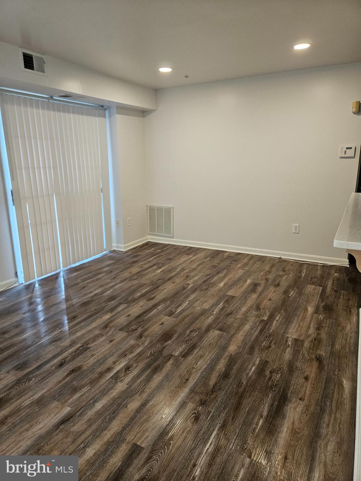 2040 Alice Avenue, Unit 2040201 Oxon Hill, MD 20745 - Photo 8 of 15 en empty room with wooden floor and fan