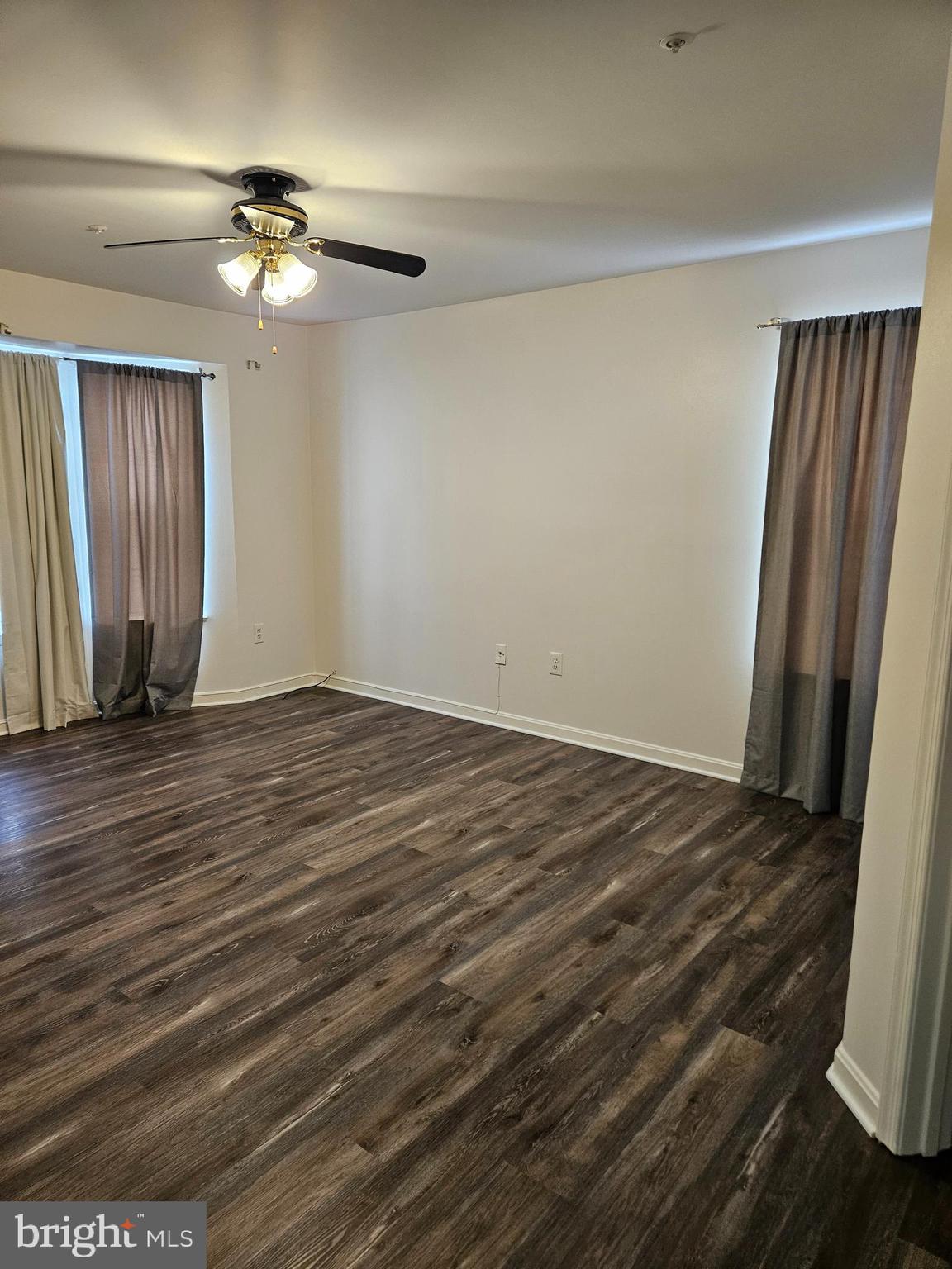 2040 Alice Avenue, Unit 2040201 Oxon Hill, MD 20745 - Photo 9 of 15 a view of an empty room with wooden floor