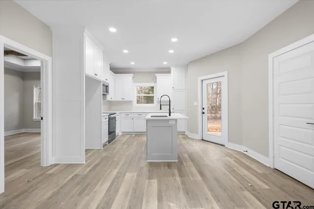 a kitchen with a refrigerator and a sink