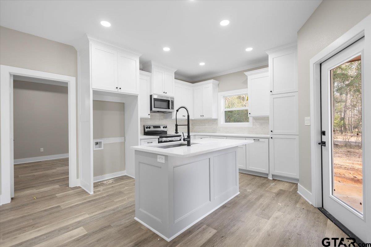 663 Caroline Bend Bullard, TX 75757 - Photo 13 of 36 a kitchen with stainless steel appliances granite countertop a sink stove and refrigerator