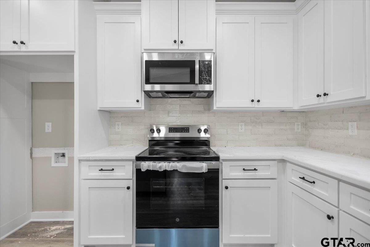 663 Caroline Bend Bullard, TX 75757 - Photo 15 of 36 a kitchen with white cabinets and stainless steel appliances