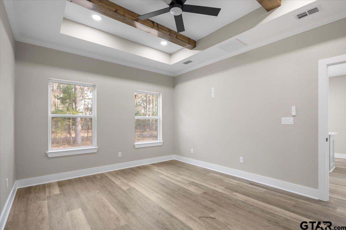 663 Caroline Bend Bullard, TX 75757 - Photo 19 of 36 an empty room with wooden floor and windows