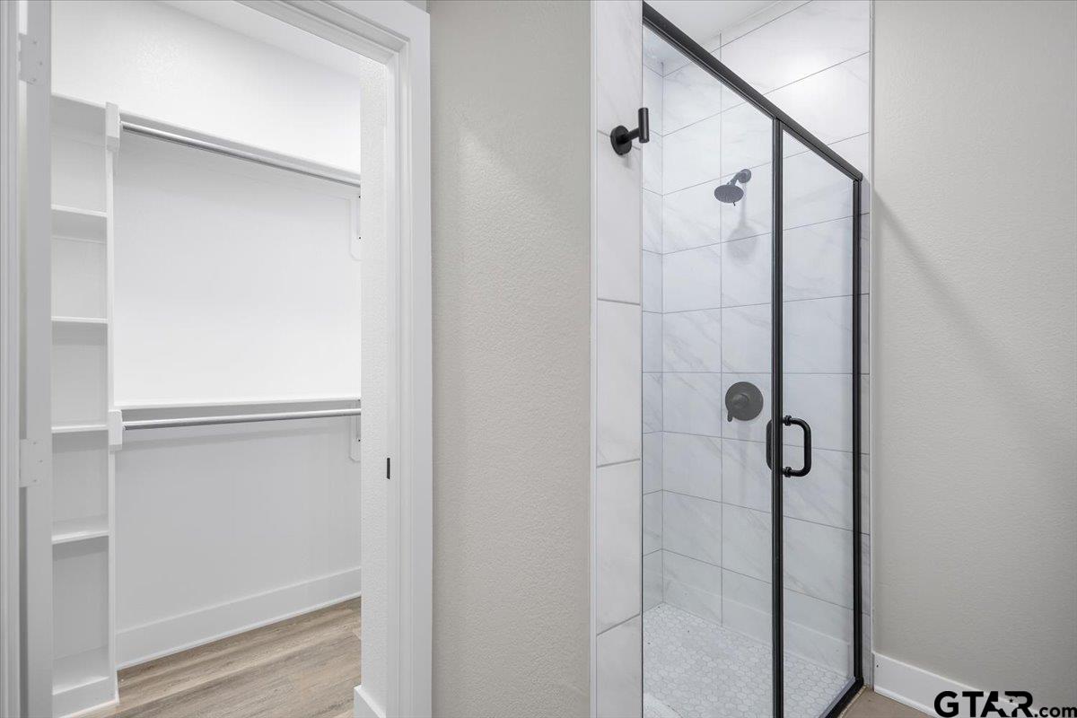 663 Caroline Bend Bullard, TX 75757 - Photo 22 of 36 a bathroom with a glass shower door