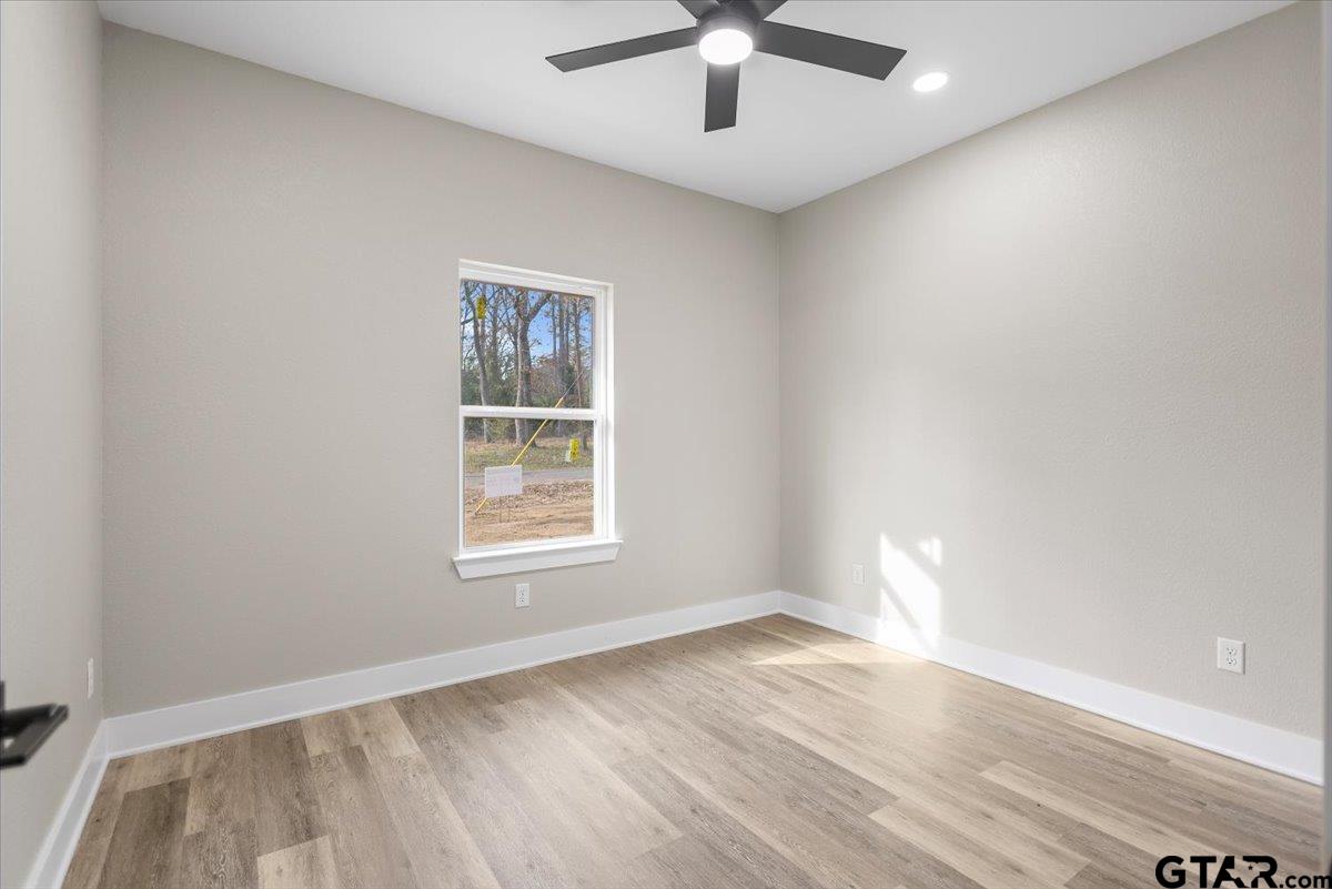 663 Caroline Bend Bullard, TX 75757 - Photo 24 of 36 an empty room with wooden floor and windows