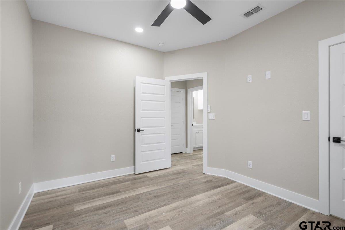 663 Caroline Bend Bullard, TX 75757 - Photo 29 of 36 an empty room with wooden floor and ceiling fan