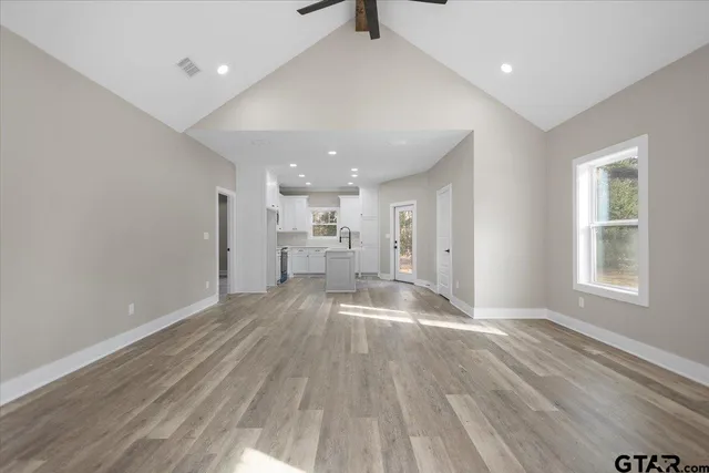 a view of empty room with wooden floor