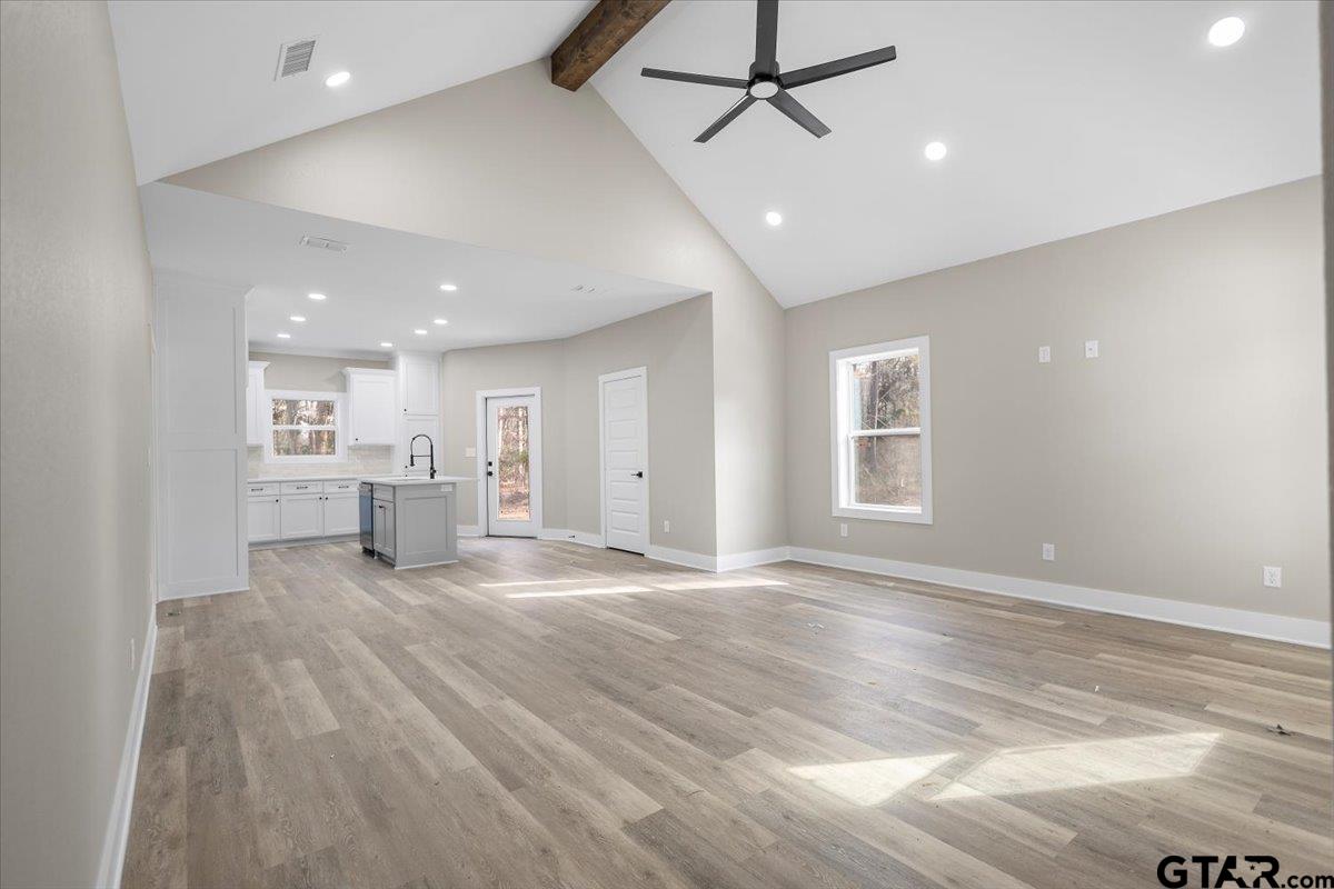 663 Caroline Bend Bullard, TX 75757 - Photo 8 of 36 a view of an empty room with a window and kitchen view