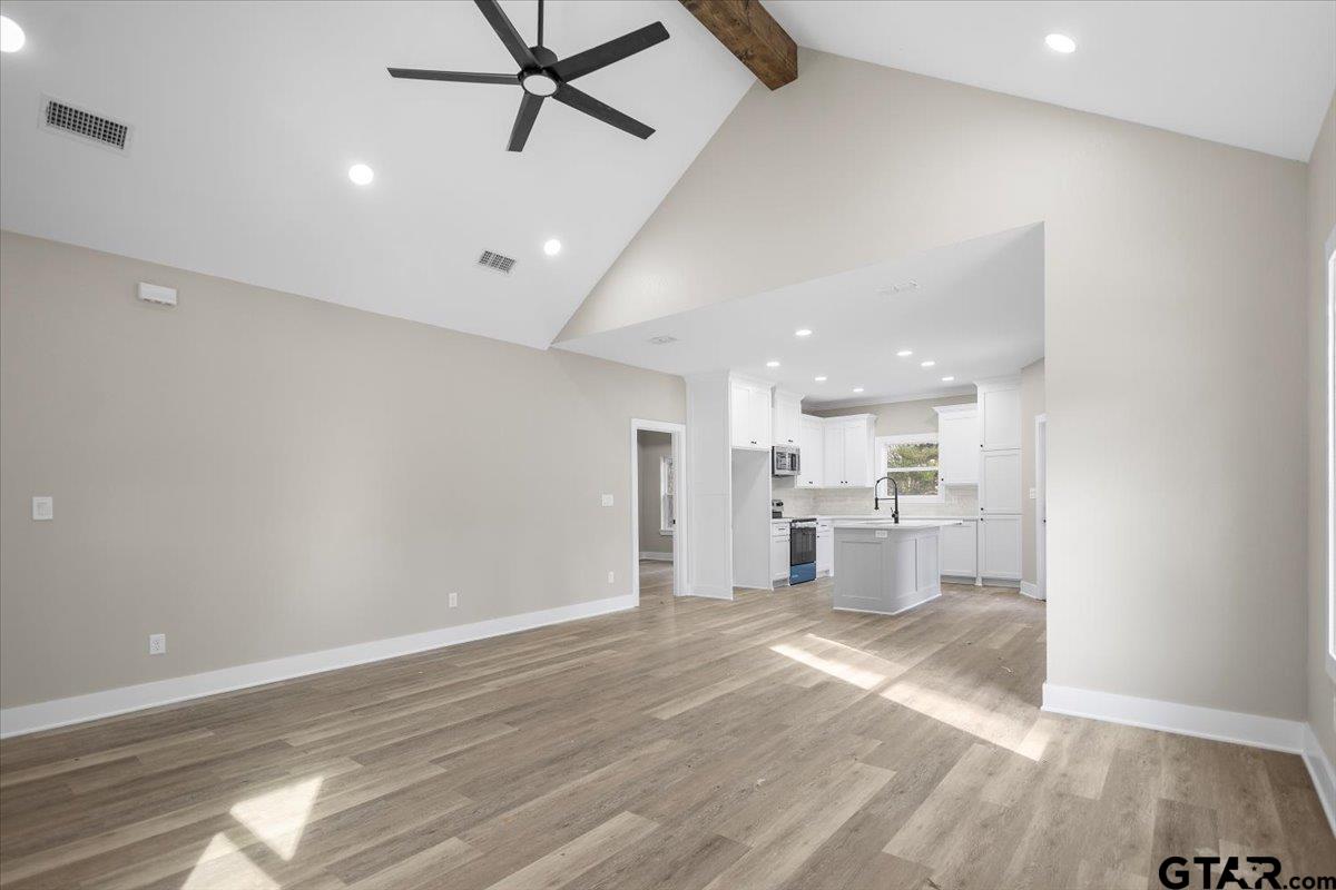 663 Caroline Bend Bullard, TX 75757 - Photo 9 of 36 a view of a kitchen with a sink and dishwasher a refrigerator with wooden floor