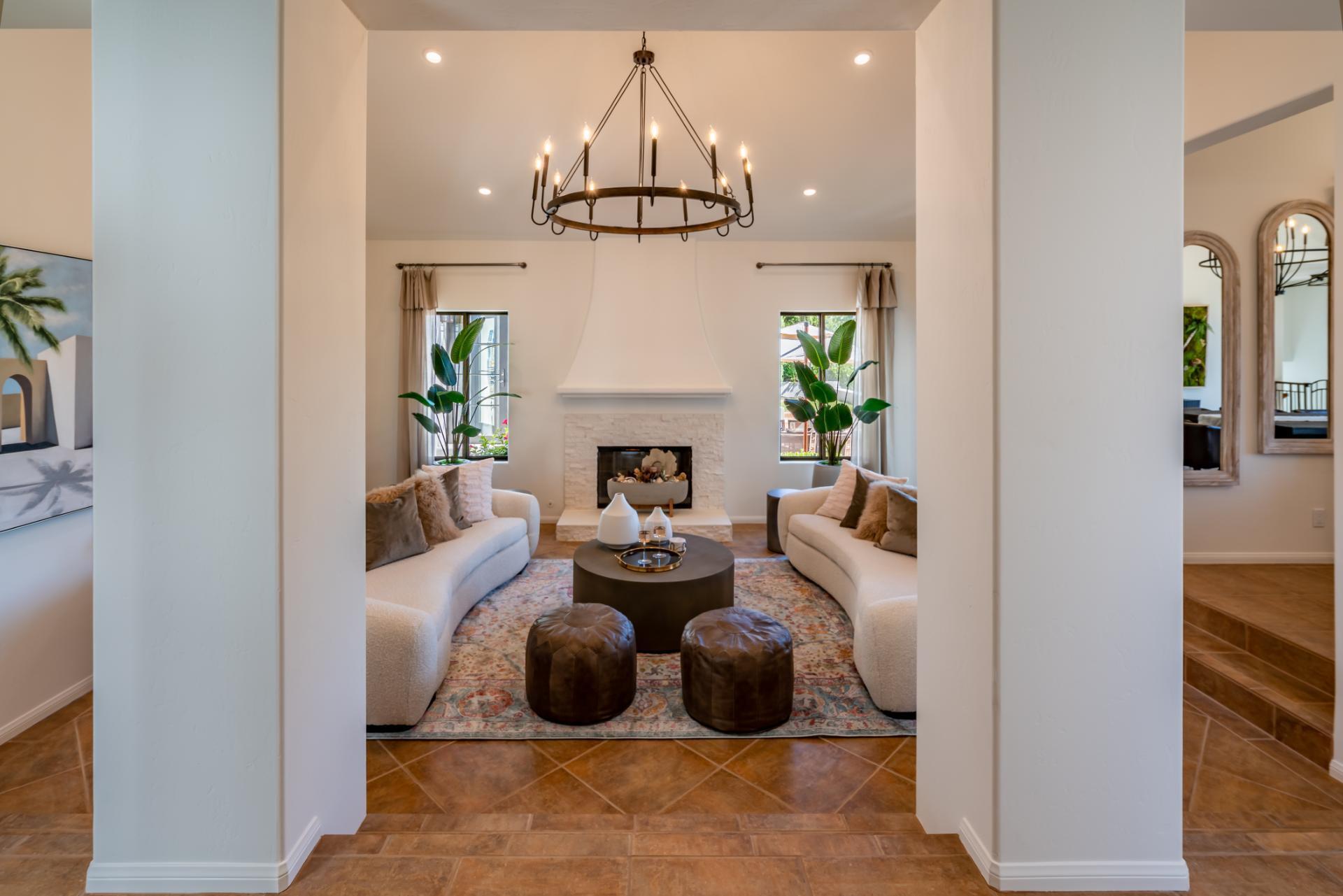 1910 Barker Pass Road Santa Barbara, CA 93108 - Photo 2 of 41 a living room with furniture a chandelier and a fireplace