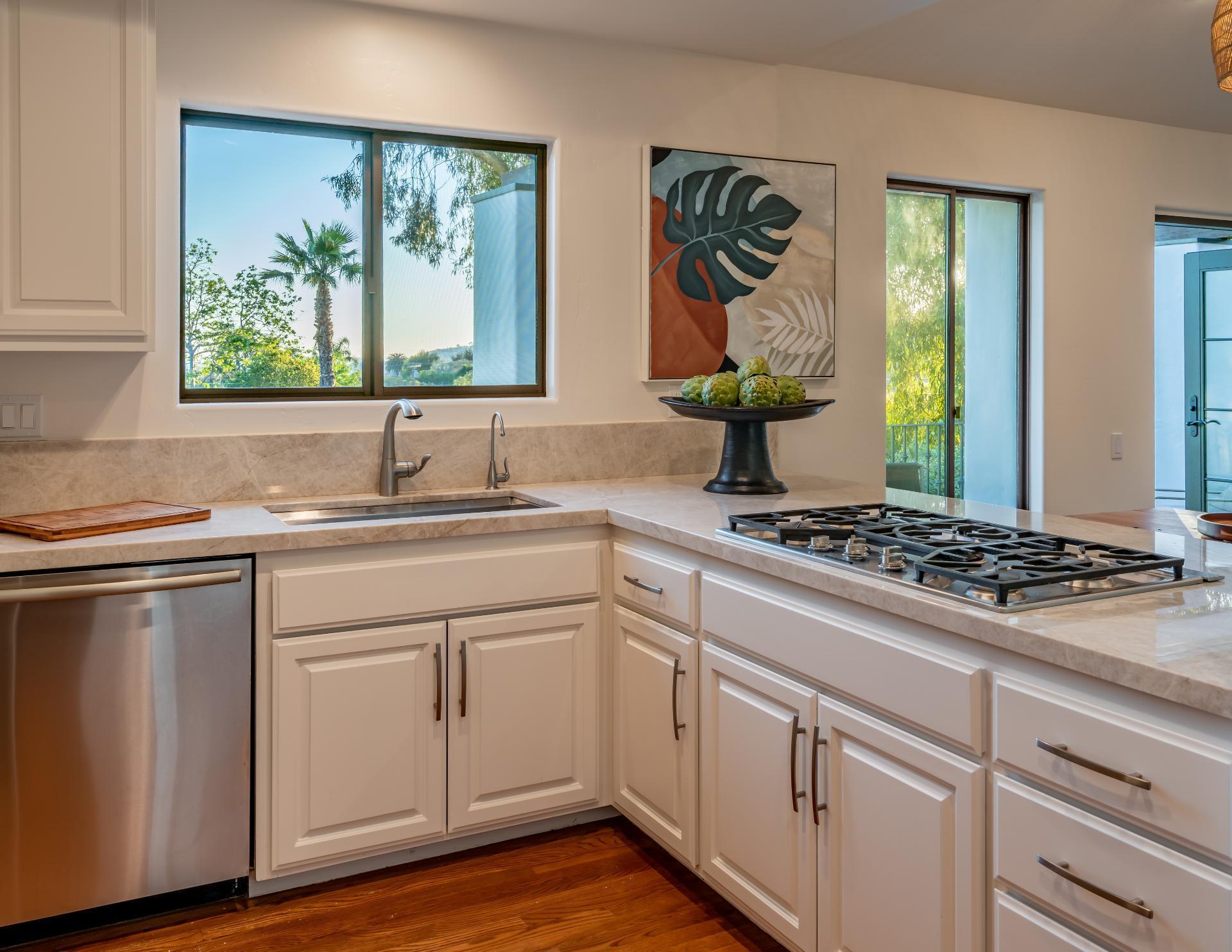 1910 Barker Pass Road Santa Barbara, CA 93108 - Photo 7 of 41 a kitchen with kitchen island granite countertop a sink cabinets and window