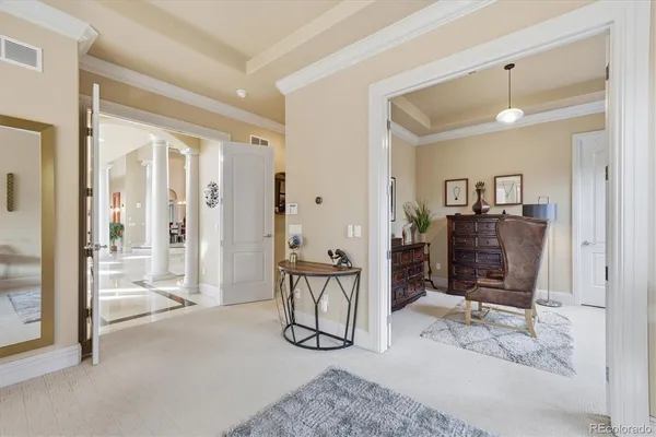 a view of a livingroom with furniture and an entryway