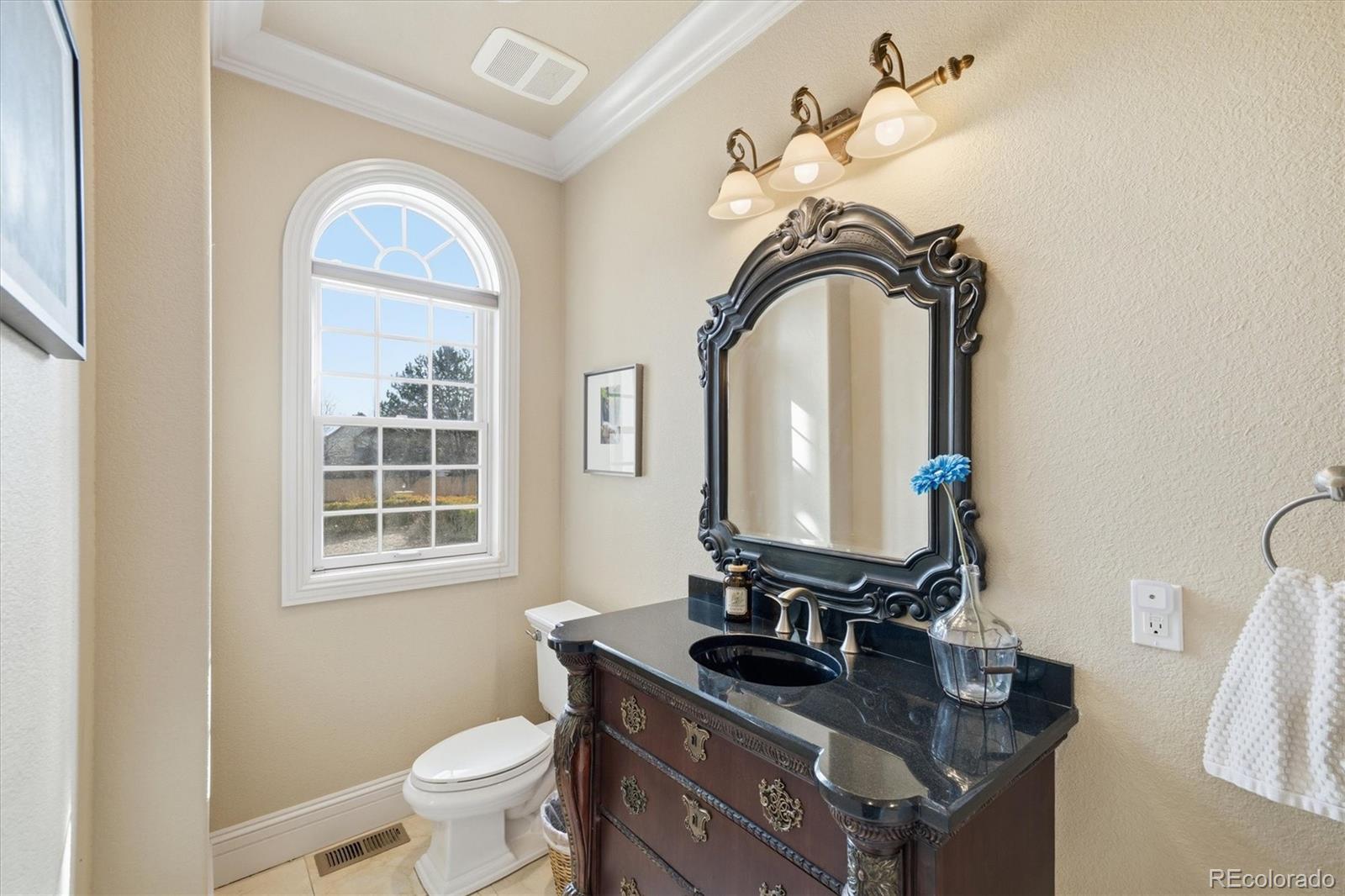 1975 South Lake Road Lakewood, CO 80227 - Photo 19 of 49 a bathroom with a toilet sink and mirror