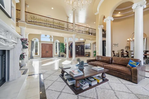 a living room with furniture a rug and a chandelier