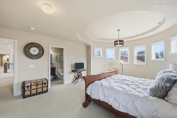 a bedroom with a bed a mirror and a desk