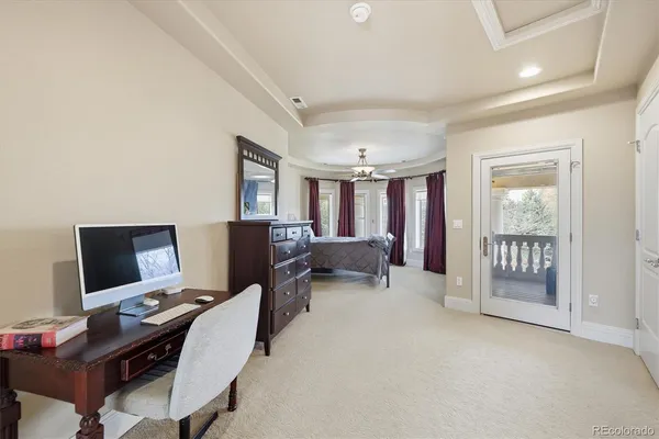 a view of a livingroom with workspace and a window