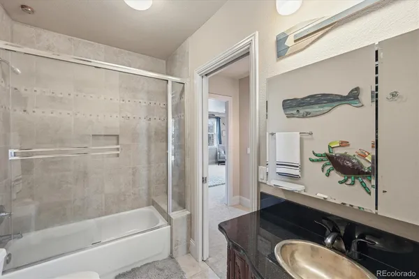 a bathroom with a sink vanity mirror and a bathtub
