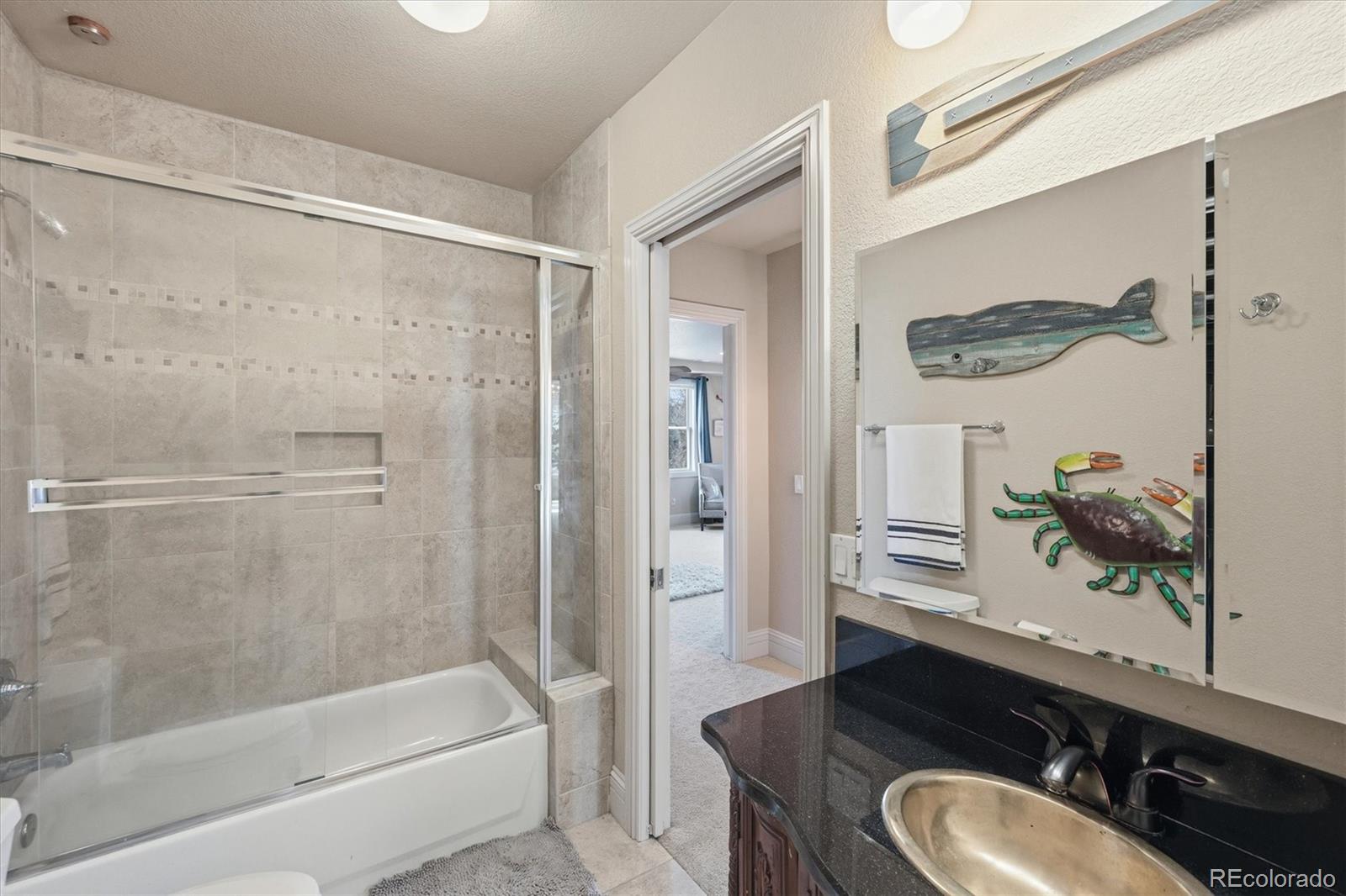 1975 South Lake Road Lakewood, CO 80227 - Photo 26 of 49 a bathroom with a sink vanity mirror and a bathtub