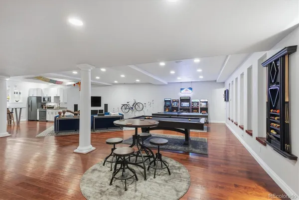 a living room with furniture and a wooden floor