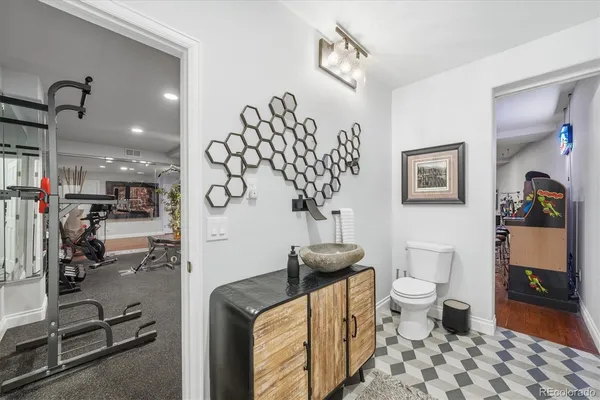 a bathroom with a sink a toilet and a mirror