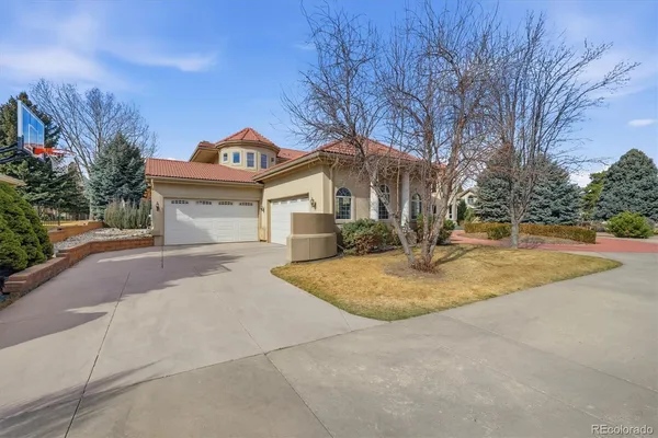 a roof deck with a table and chairs with wooden floor