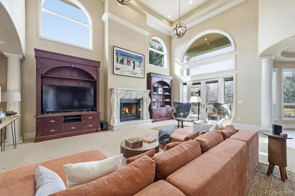 a living room with furniture a flat screen tv and a fireplace