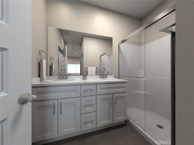a bathroom with a shower sink and mirror