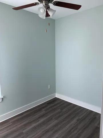 a view of a small space with wooden floor and chandelier