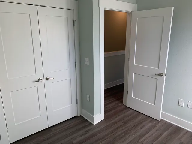 a view of an empty room with wooden floor