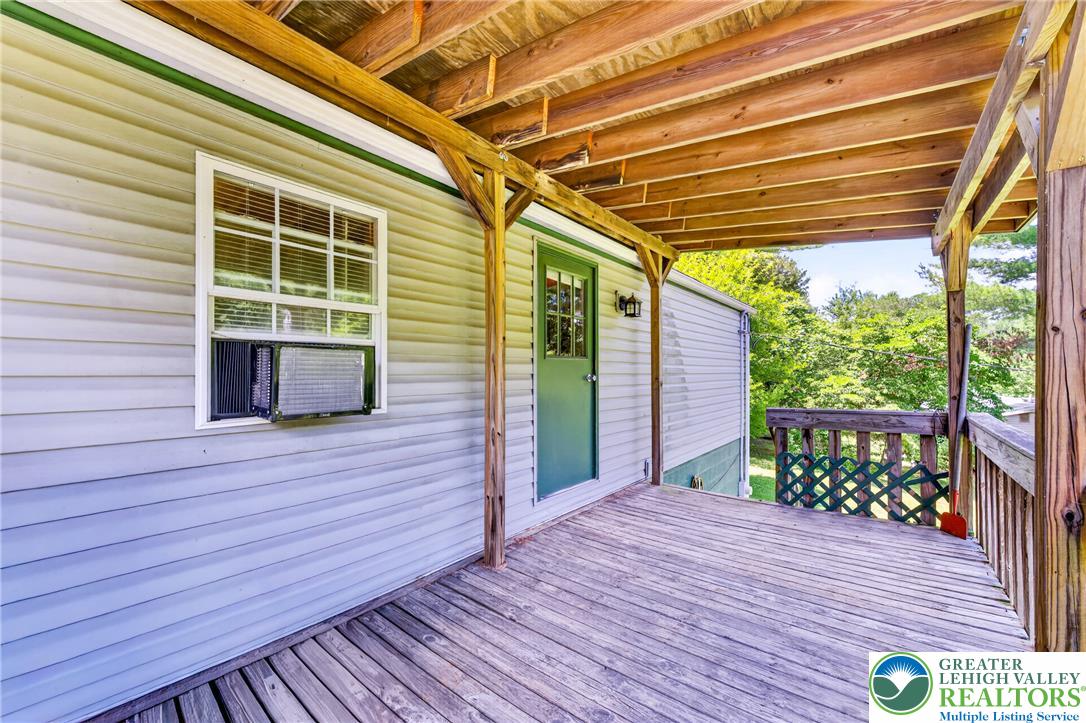 2674 Williams Road Danielsville, PA 18038 - Photo 4 of 31 A spacious wooden deck extends from the residence, perfect for enjoying the outdoor surroundings.
