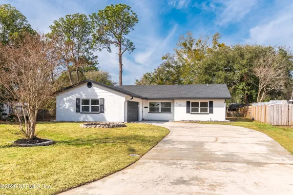 a house that has a tree in front of it