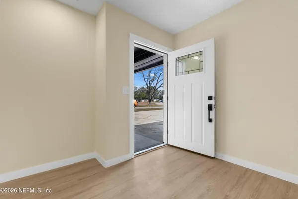an empty room with wooden floor cabinet