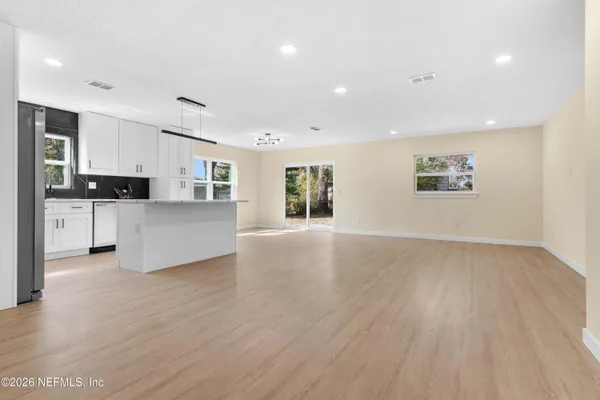 a view of a kitchen with microwave and cabinets