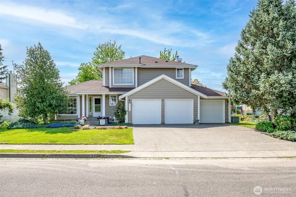 a front view of a house with a yard