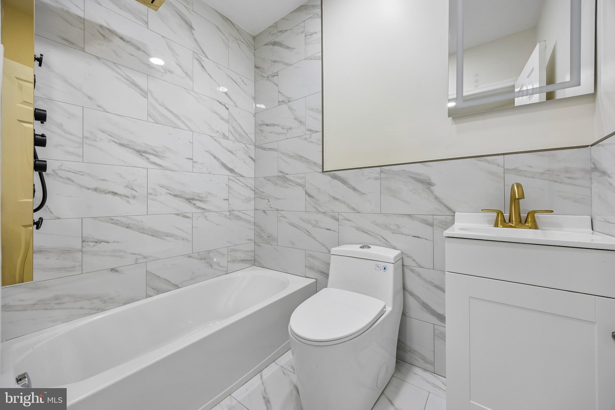 1051 Springfield Road Darby, PA 19023 - Photo 15 of 24 a bathroom with a toilet a sink and bathtub