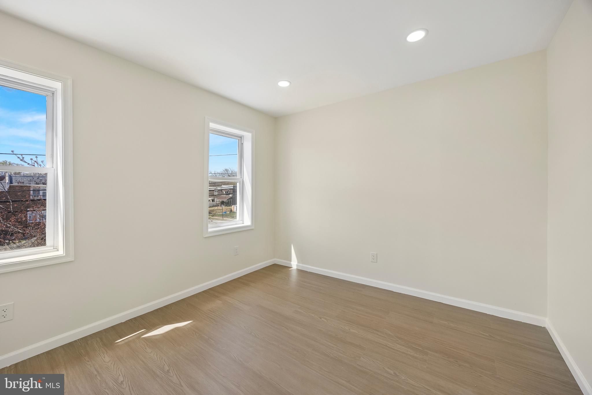 1051 Springfield Road Darby, PA 19023 - Photo 18 of 24 an empty room with wooden floor and windows