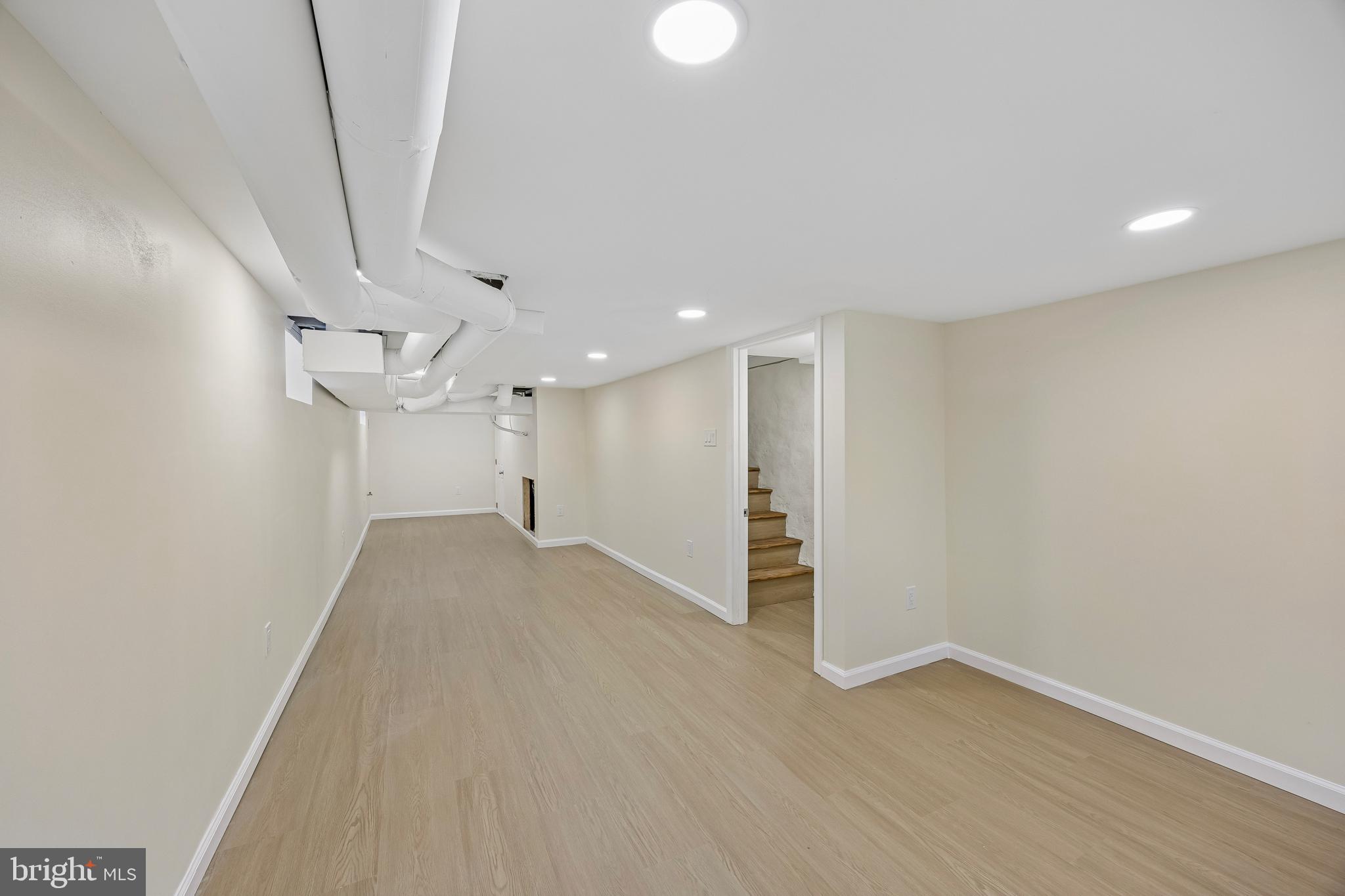 1051 Springfield Road Darby, PA 19023 - Photo 20 of 24 an empty room with wooden floor and windows