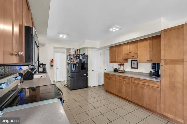 a kitchen with a sink appliances and cabinets