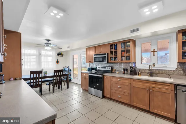 a kitchen with lots of counter top space and dining table