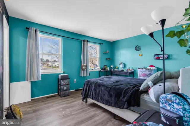 a bedroom with a bed and windows