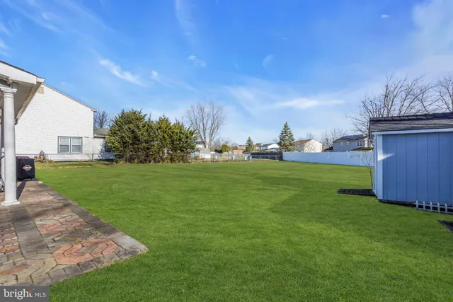 a view of a field of grass and trees