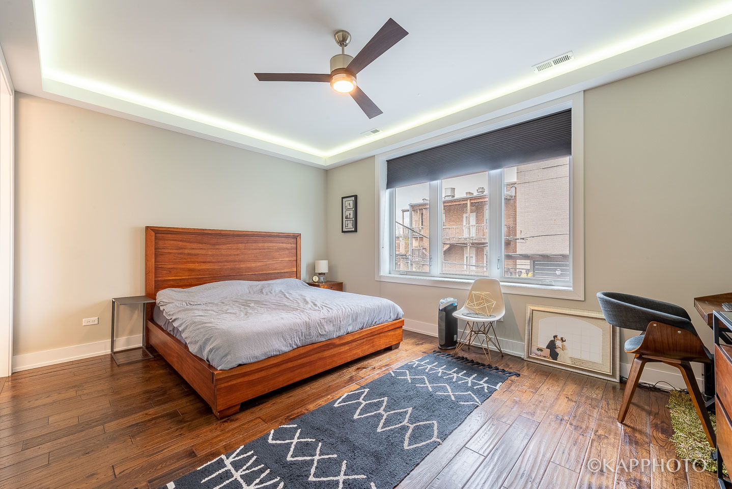 1430 West Fillmore Street, Unit 2W Chicago, IL 60607 - Photo 13 of 27 a bedroom with wooden floors and a bed