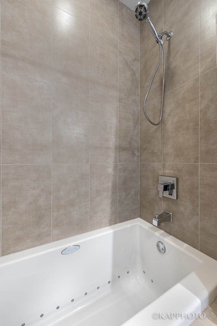 1430 West Fillmore Street, Unit 2W Chicago, IL 60607 - Photo 23 of 27 a bathroom with a bathtub and a shower